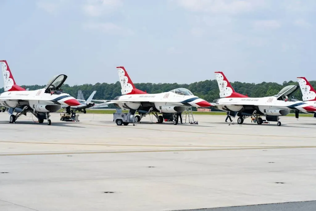 Military pilots standing in front of fighter aircraft