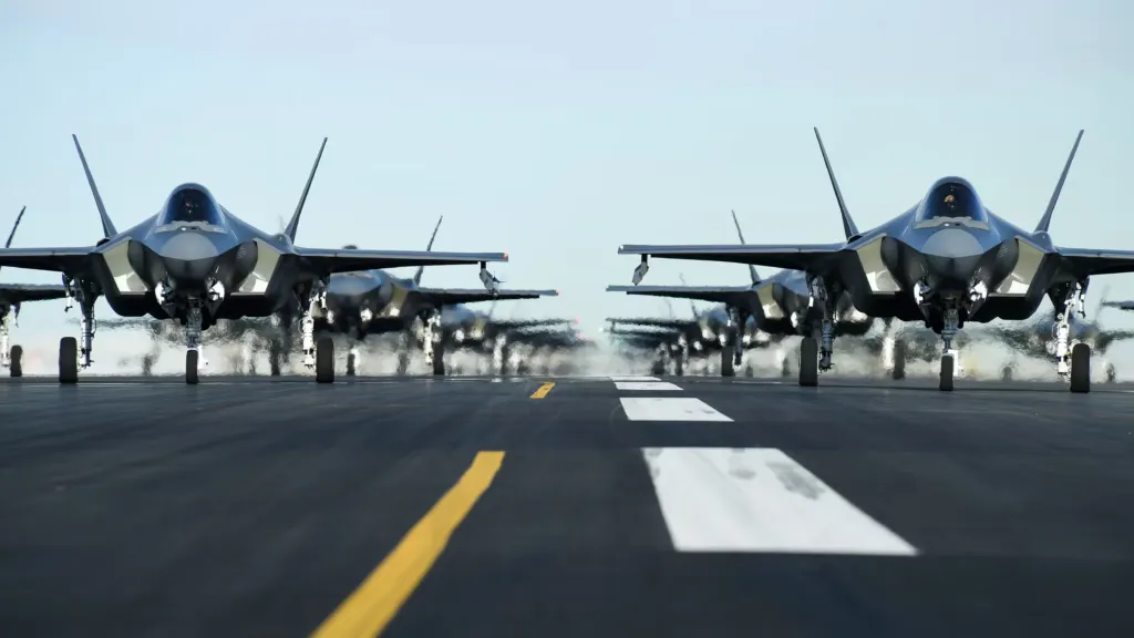 Multiple fighter aircraft from different manufacturers lined up on runway