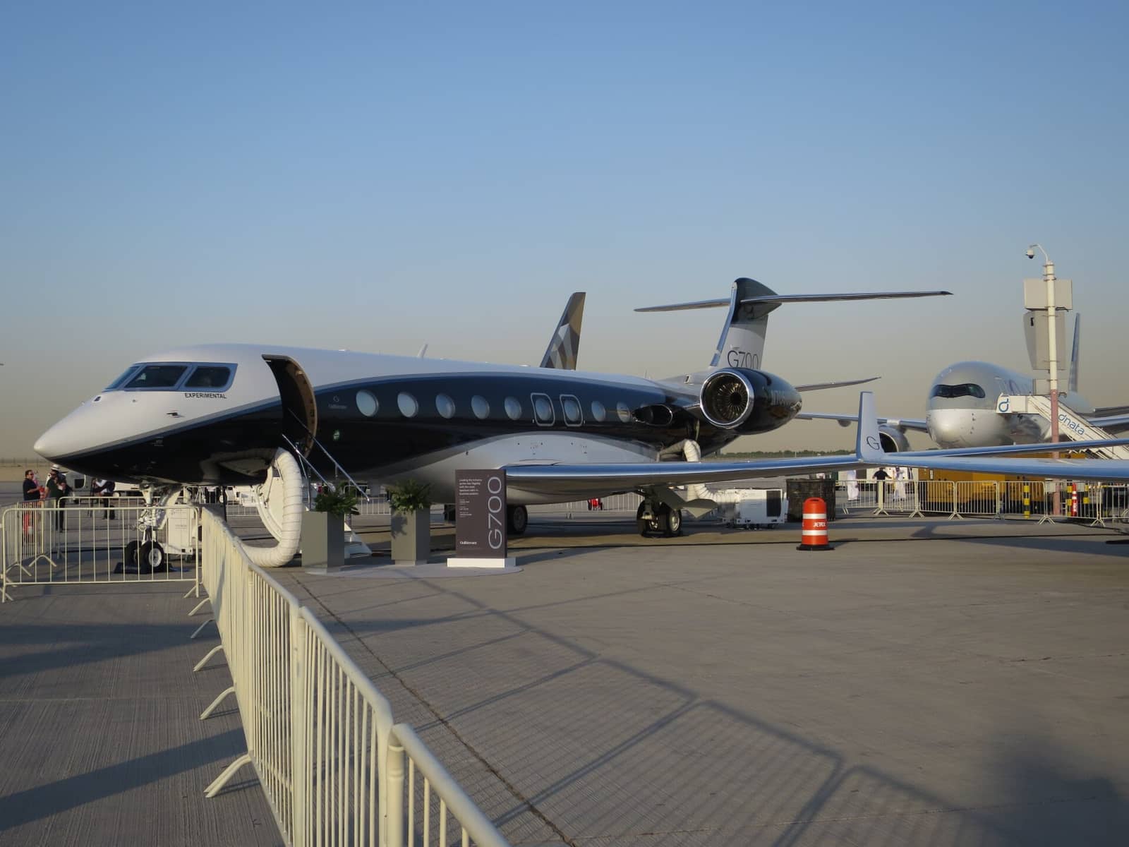 Gulfstream G700 business jet on static display at the Dubai Airshow 2023, with an airliner behind it