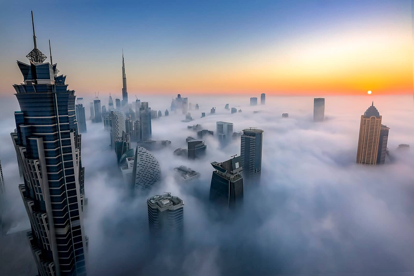 View of Dubai sykline taken from Al Habtoor City, Noora Tower, at sunrise on a foggy day, Dubai, United Arab Emirates.