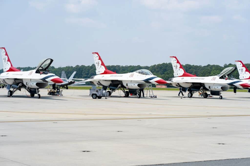 Military pilots standing in front of fighter aircraft
