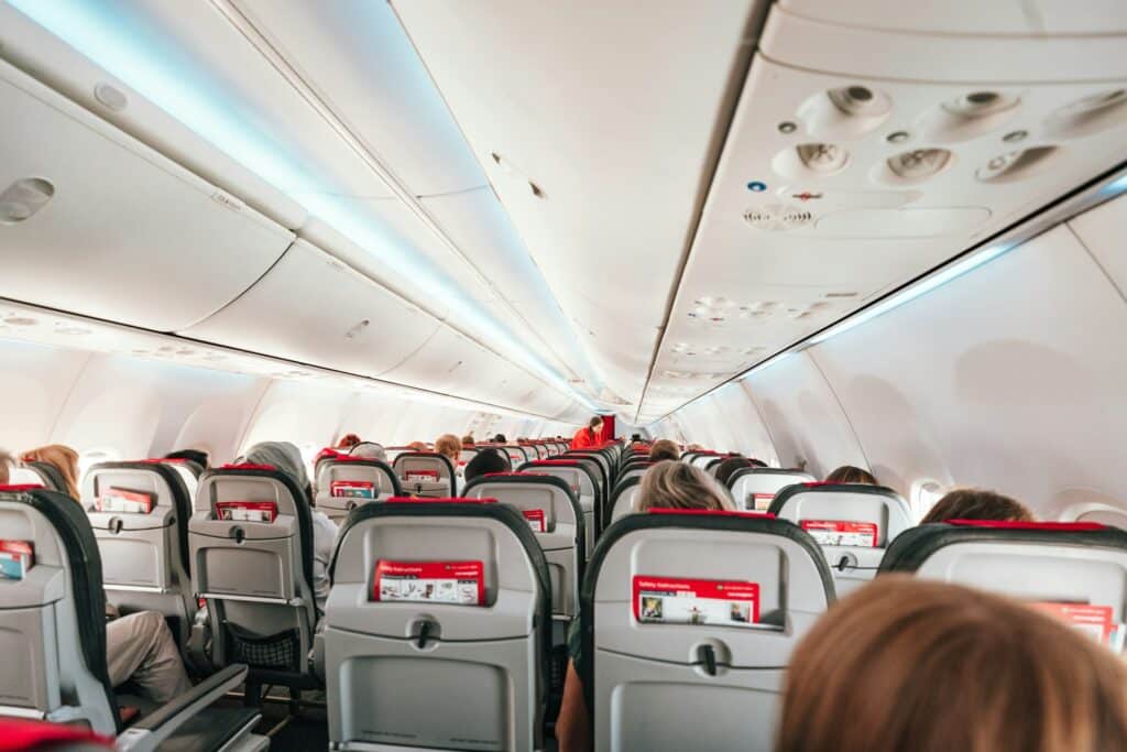 airplane cabin with passengers seated
